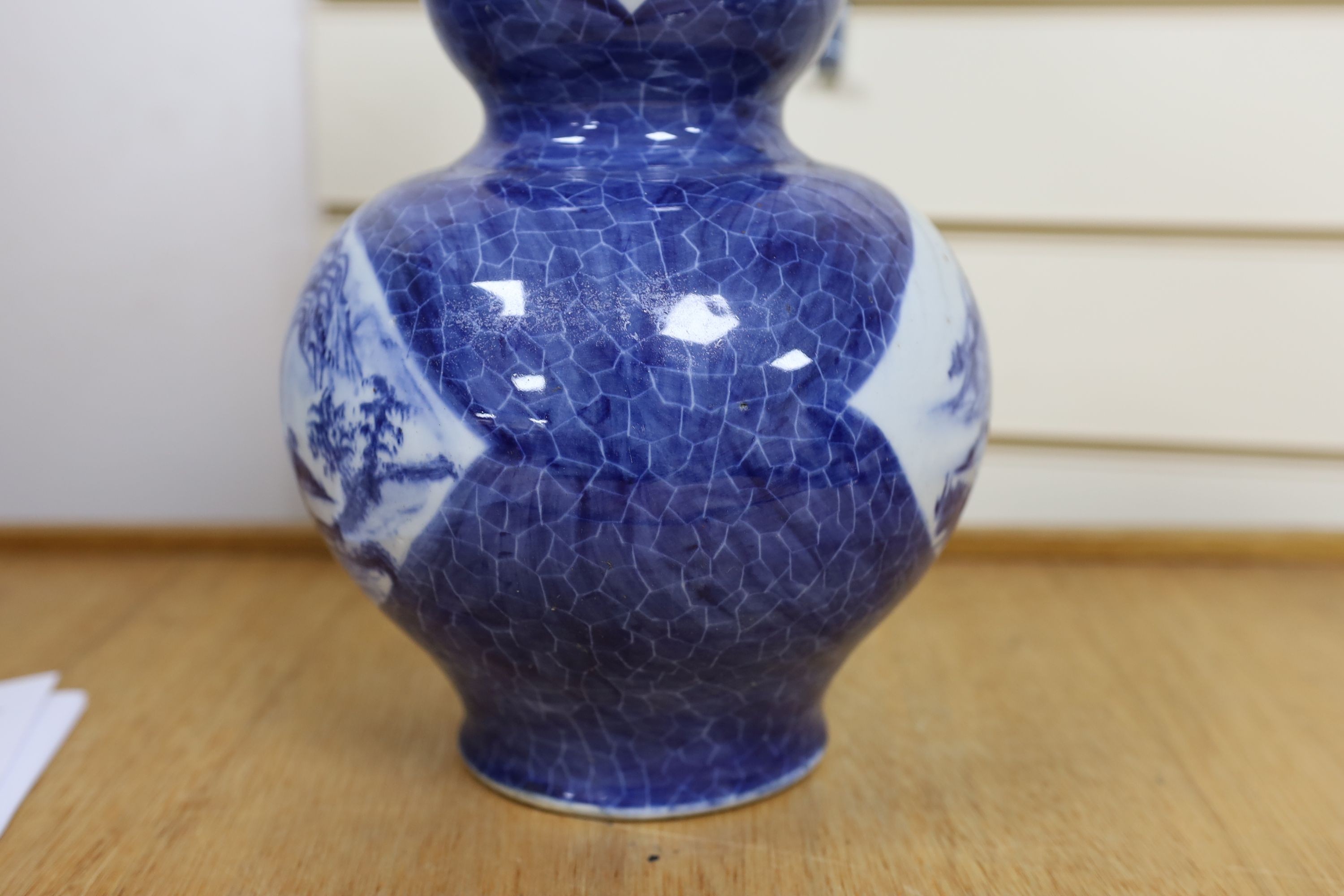 A Chinese blue and white gourd vase with landscape decoration, a similar blue and white sleeve vase and a Japanese Kutani vase